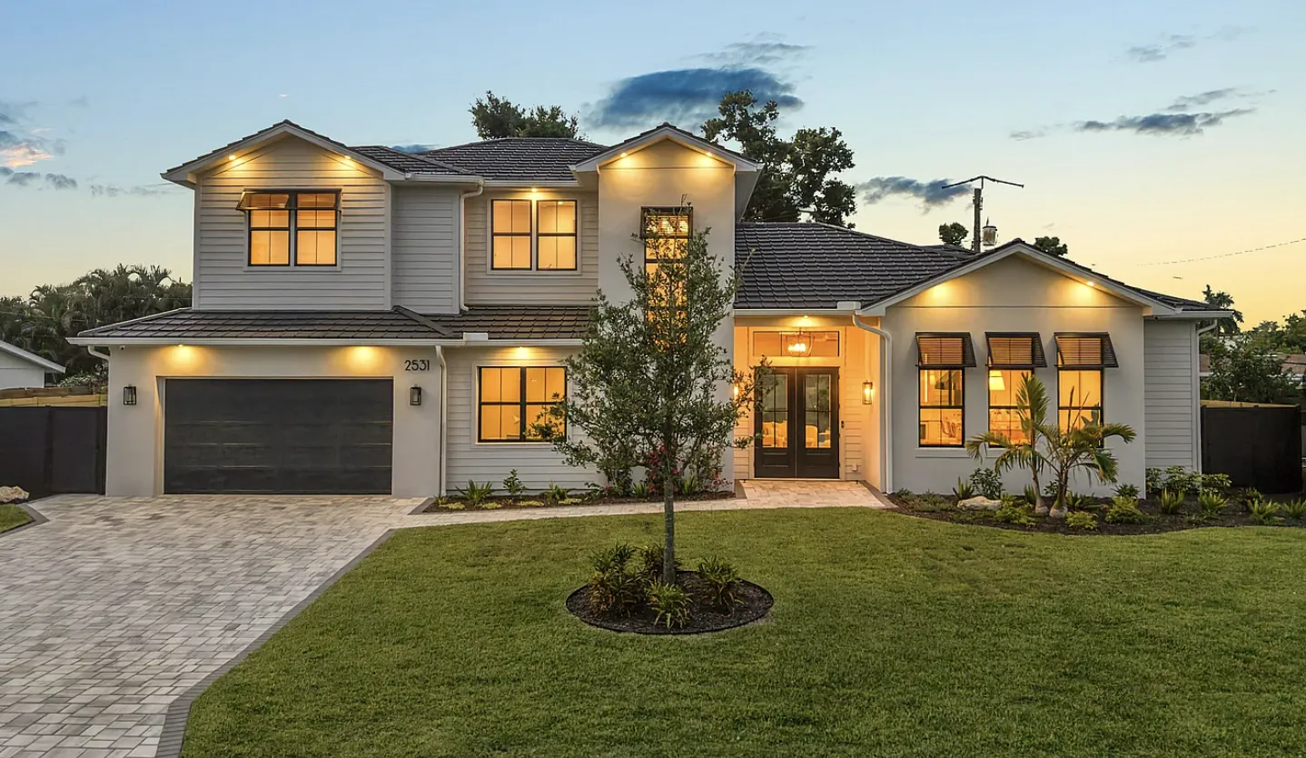 Custom home exterior illuminated at dusk